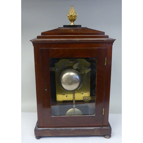 60 - A George III mahogany cased bracket clock with a stepped top, gilt metal pineapple finial and brass ... 