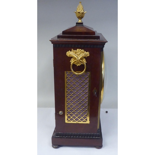 60 - A George III mahogany cased bracket clock with a stepped top, gilt metal pineapple finial and brass ... 