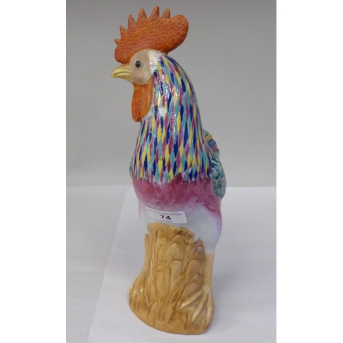 74 - A mid 20thC Chinese porcelain famille rose model cockerel, brightly enamelled in naturalistic tones ... 