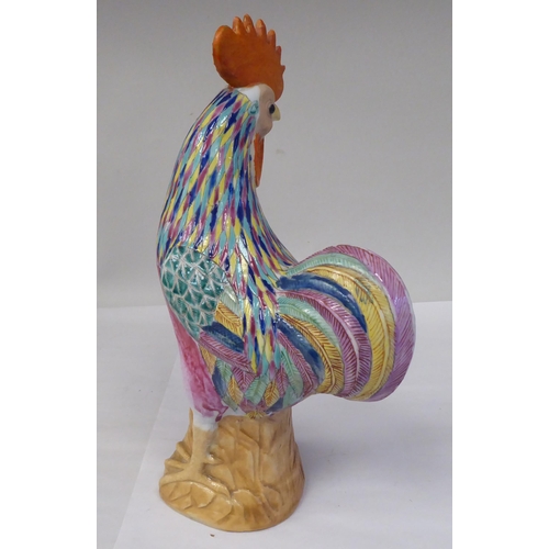 74 - A mid 20thC Chinese porcelain famille rose model cockerel, brightly enamelled in naturalistic tones ... 