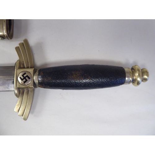 75 - A Third Reich period DLV Flyer's dress knife with nickel plated fittings, an enamelled swastika on t... 