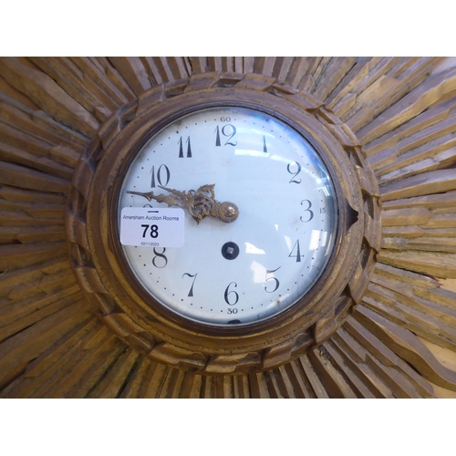 78 - An early 20thC carved giltwood cased sunburst wall clock; the movement faced by a convex white ename... 