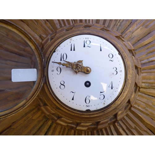 78 - An early 20thC carved giltwood cased sunburst wall clock; the movement faced by a convex white ename... 