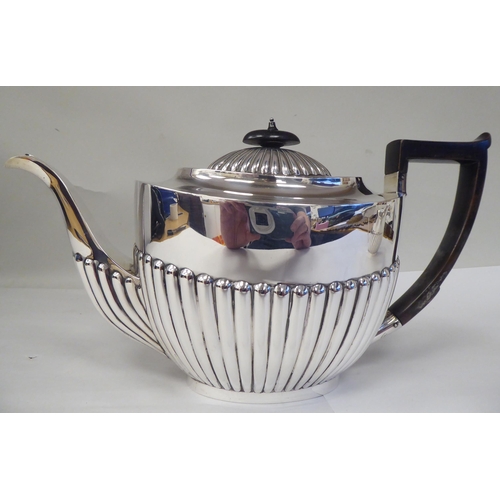 82 - A late Victorian four piece silver tea set of oval, demi-reeded form  comprising a teapot and pedest... 