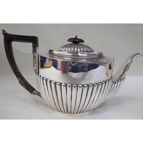 82 - A late Victorian four piece silver tea set of oval, demi-reeded form  comprising a teapot and pedest... 