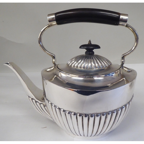 82 - A late Victorian four piece silver tea set of oval, demi-reeded form  comprising a teapot and pedest... 