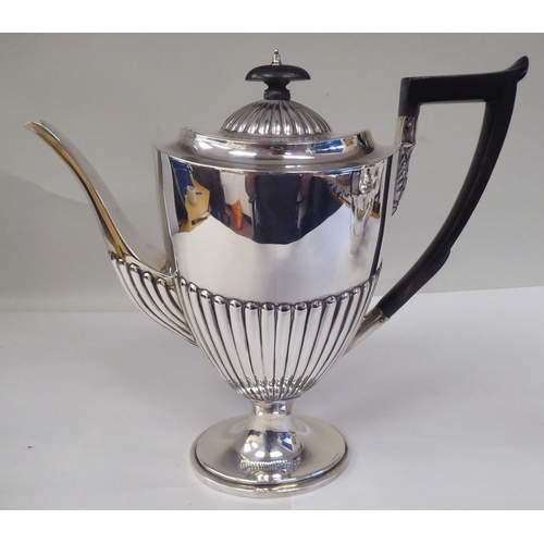 82 - A late Victorian four piece silver tea set of oval, demi-reeded form  comprising a teapot and pedest... 