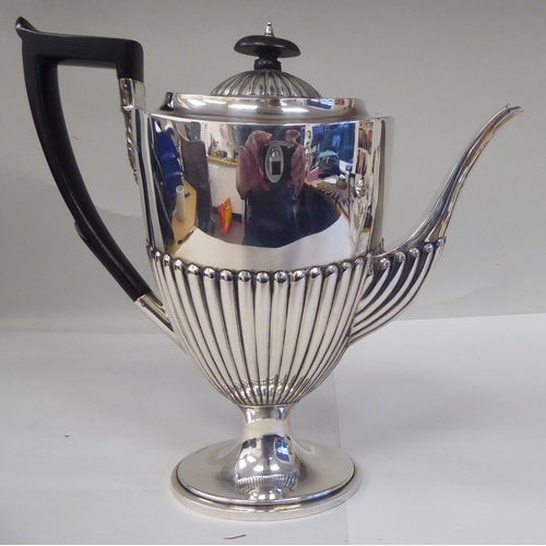 82 - A late Victorian four piece silver tea set of oval, demi-reeded form  comprising a teapot and pedest... 