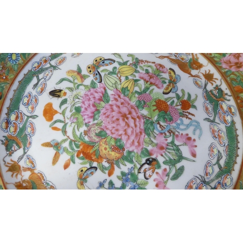 96 - A 19thC Chinese porcelain dish, decorated in famille rose and gilding with fruit, insects and dragon... 