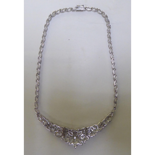 227 - A silver necklace, set with multiple white stones