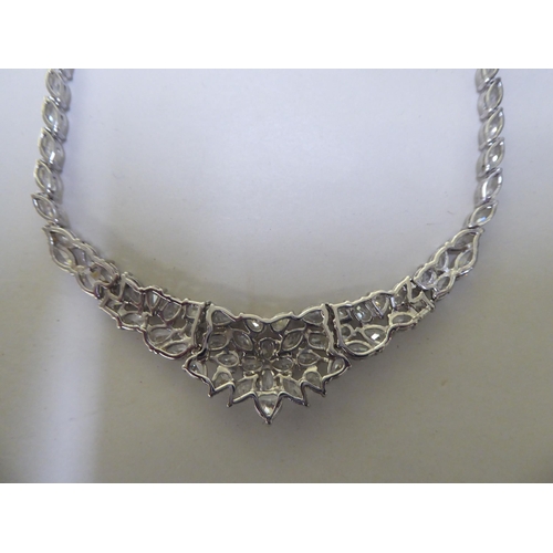 227 - A silver necklace, set with multiple white stones