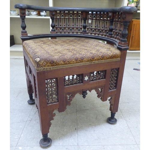 240 - A late 19thC Moorish mother-of-pearl inlaid fruitwood corner chair with an upholstered seat, raised ... 