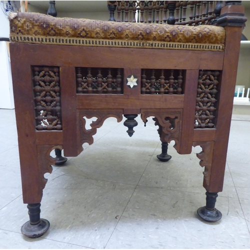 240 - A late 19thC Moorish mother-of-pearl inlaid fruitwood corner chair with an upholstered seat, raised ... 