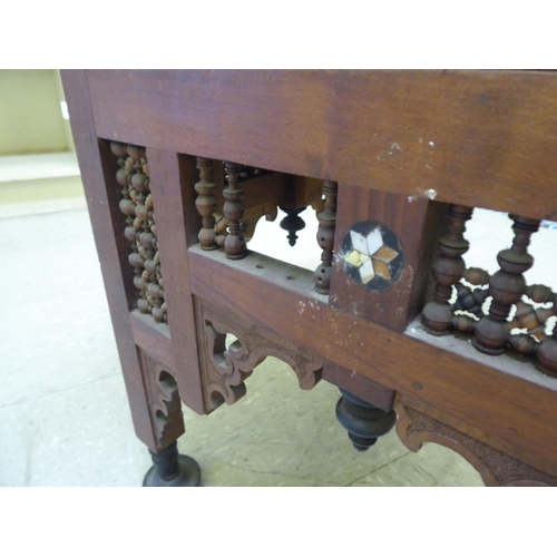 240 - A late 19thC Moorish mother-of-pearl inlaid fruitwood corner chair with an upholstered seat, raised ... 