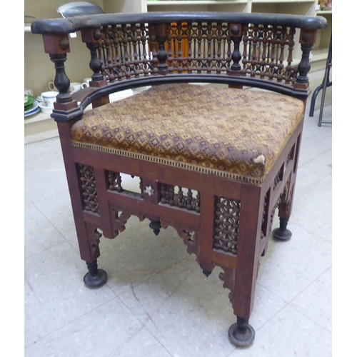 240 - A late 19thC Moorish mother-of-pearl inlaid fruitwood corner chair with an upholstered seat, raised ... 