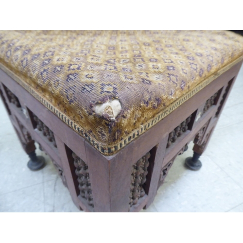 240 - A late 19thC Moorish mother-of-pearl inlaid fruitwood corner chair with an upholstered seat, raised ... 