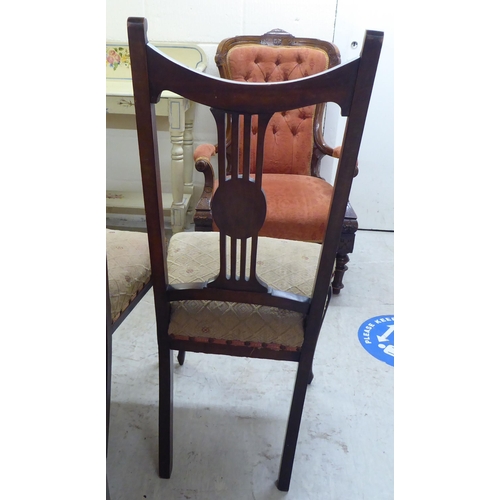 228 - A set of four Edwardian mahogany framed salon chairs, each with a splat back and upholstered seat, r... 