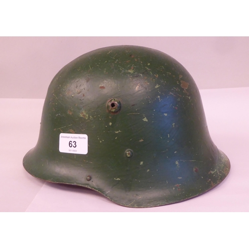 150 - A military design, painted steel helmet with a hide liner and buckled chinstrap(Please Note: this lo... 