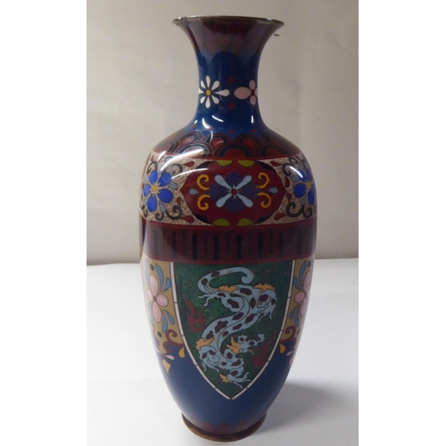 151 - An early 20thC cloisonné shouldered, baluster shape vase, decorated in colours and panels, depicting... 