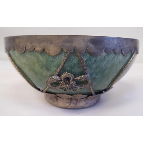 218 - A 20thC Chinese green jadeite bowl, set in a white metal frame  4.25