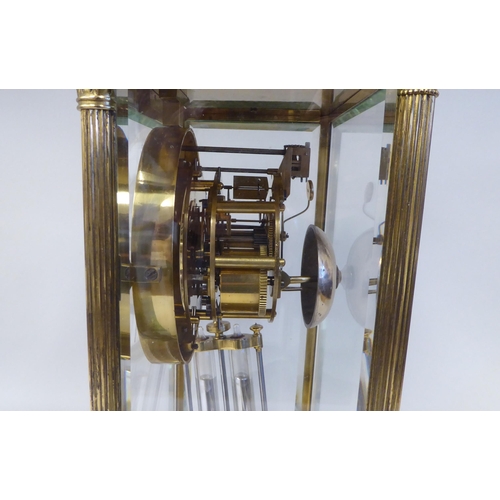 298 - A late Victorian lacquered brass, four glass mantel clock with bevelled panels; the visible bell str... 