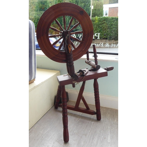 101 - A 20thC stained pine spinning wheel  46