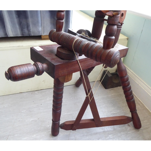 101 - A 20thC stained pine spinning wheel  46