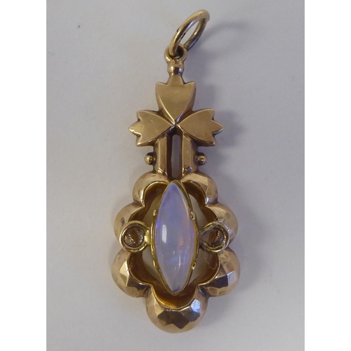 109 - A yellow metal pendant, set with a central opal, featuring a floral motif  stamped 9ct 