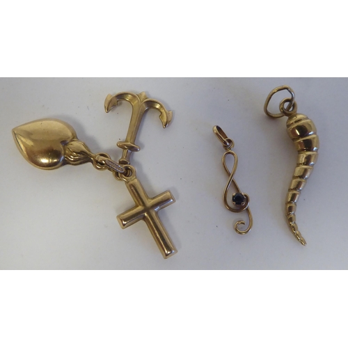 116 - 9ct gold charm bracelet accessories: to include examples fashioned as hearts; and an anchor 