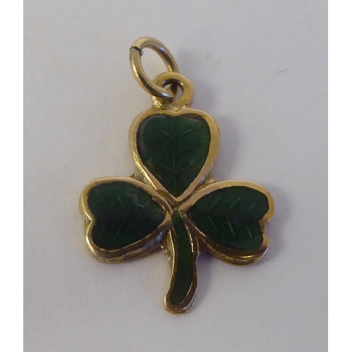 124 - A 9ct gold enamelled pendant, fashioned as a three leaf clover  