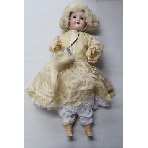 15 - An early 20thC Max Oscar Arnold Welsch bisque head doll with painted features, on a jointed composit... 