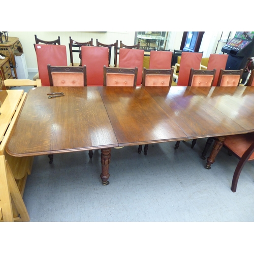 159 - A late Victorian oak dining table, the top with  thumb moulded edge, raised on turned, tapered legs ... 