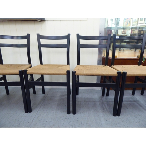 162 - A set of eight modern black painted, twin bar back chairs with rush seats