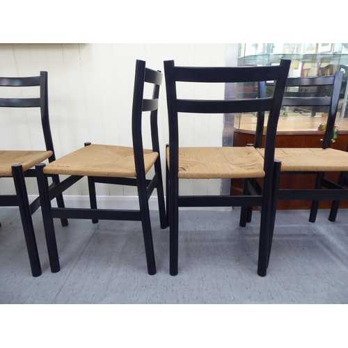 162 - A set of eight modern black painted, twin bar back chairs with rush seats