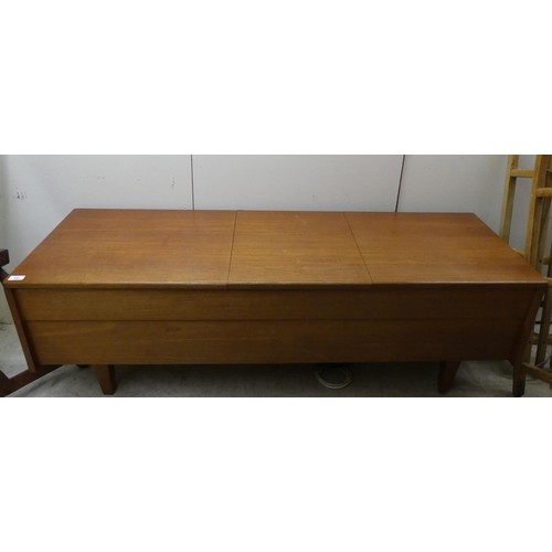 163 - A 1960/1970s Leak teak cased low cabinet with three hinged flaps, containing a stereo 30 and a Garra... 