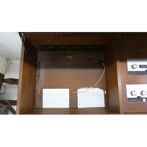 163 - A 1960/1970s Leak teak cased low cabinet with three hinged flaps, containing a stereo 30 and a Garra... 