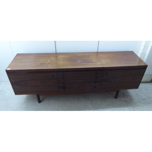 179 - Attributed to Robert Heritage for Archie Shine, a 1960s rosewood sideboard, the top with a rising an... 