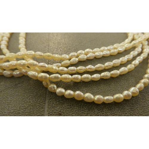 180 - A freshwater pearl necklace, consisting of five strands, connected by a white metal clasp  stam... 