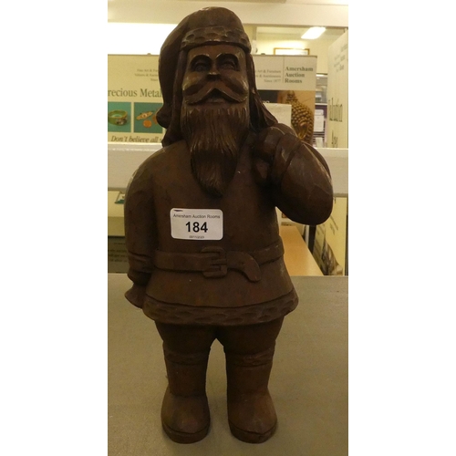 184 - A carved wooden figure, Father Christmas carrying a sack  13