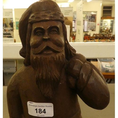 184 - A carved wooden figure, Father Christmas carrying a sack  13