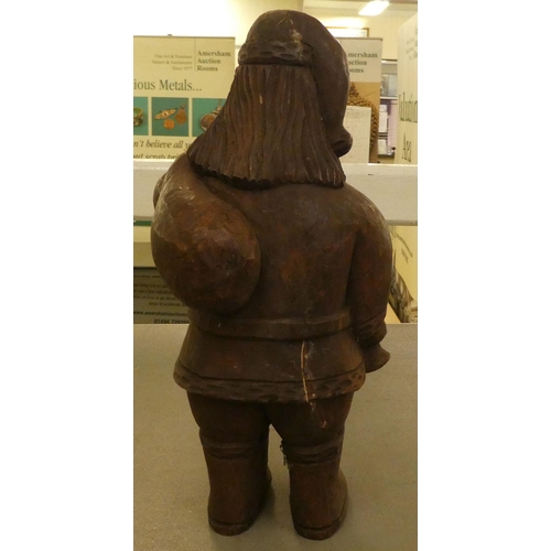 184 - A carved wooden figure, Father Christmas carrying a sack  13