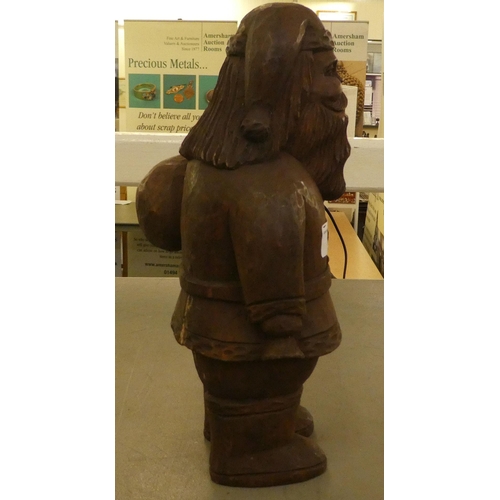 184 - A carved wooden figure, Father Christmas carrying a sack  13