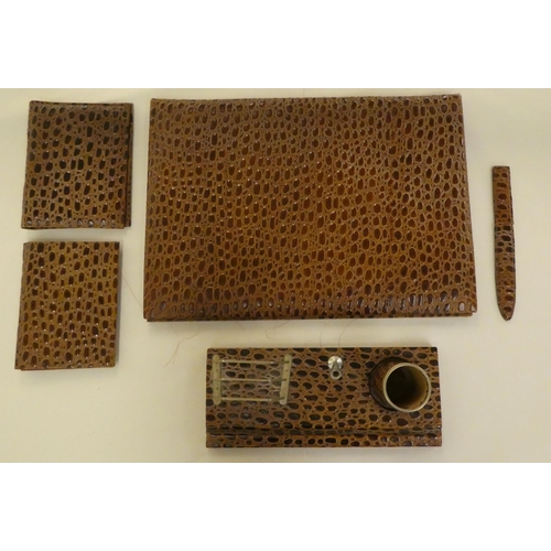 189 - A modern crocodile skin effect desk set, comprising a desk tidy, a blotter, letter knife and folders