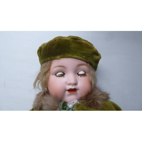 2 - An early 20thC Armand Marseille 990 bisque head doll with painted features, on a jointed compos... 