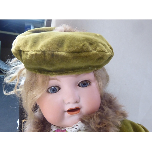 2 - An early 20thC Armand Marseille 990 bisque head doll with painted features, on a jointed compos... 