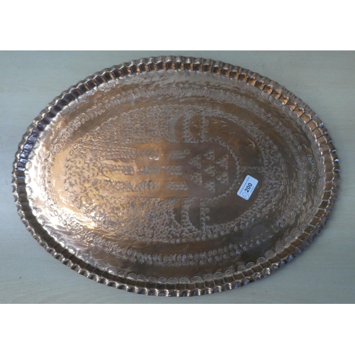 200 - An oval copper tray, impressed with repeating designs  stamped CPC  1970  22