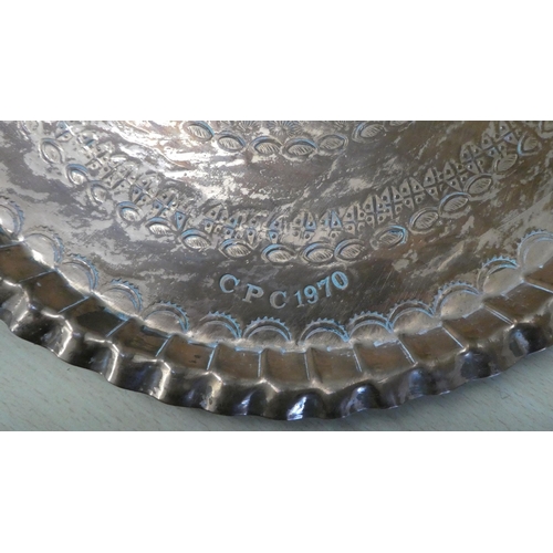 200 - An oval copper tray, impressed with repeating designs  stamped CPC  1970  22