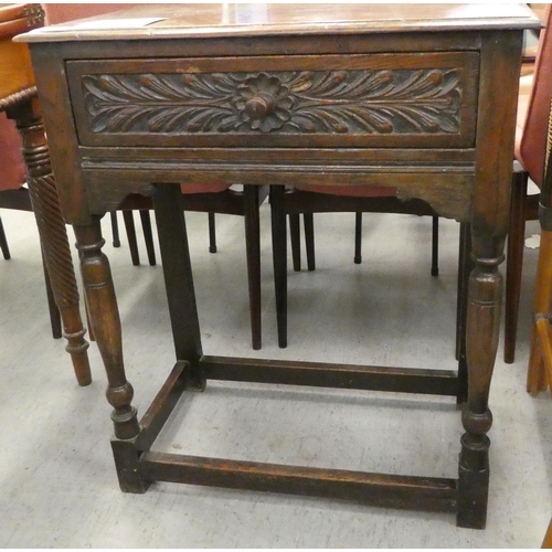 22 - An early 20thC Jacobean style, oak single drawer side table, raised on turned and block legs  3... 