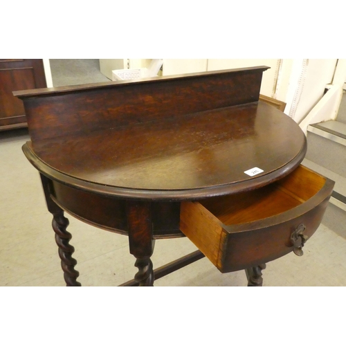 245 - A 1930s oak demi-lune single drawer side table, raised on barleytwist legs  34