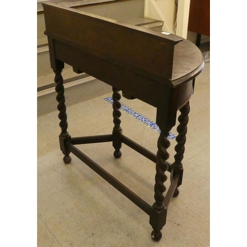 245 - A 1930s oak demi-lune single drawer side table, raised on barleytwist legs  34